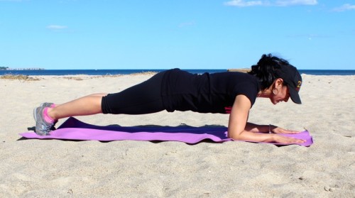 Aimee Borda performing a plank. This exercise is great for your core and can be done indoors or outdoors.